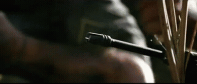A Close Up Of A Person Holding A Gun And A Knife . GIF
