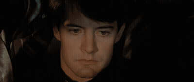 A Close Up Of A Person Holding A Knife In Their Mouth GIF