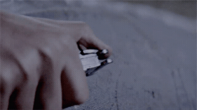 A Close Up Of A Person Holding A Knife With A Clear Handle GIF