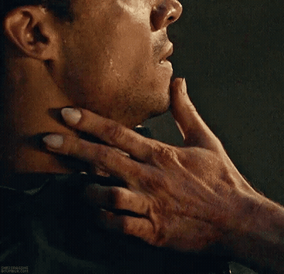 A Close Up Of A Person Holding A Man 'S Neck With Their Hand . GIF