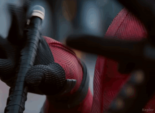 A Close Up Of A Person Holding A Microphone With A Rope Around It . GIF