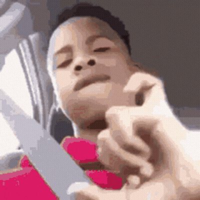 A Close Up Of A Person Holding A Pair Of Scissors . GIF