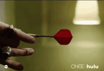 A Close Up Of A Person Holding A Red Dart With The Word Hulu On The Bottom GIF