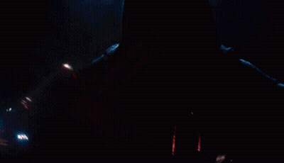 A Close Up Of A Person Holding A Red Light Saber In The Dark GIF