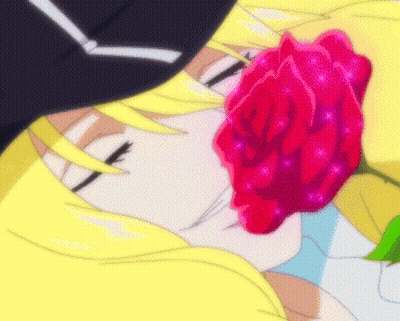 A Close Up Of A Person Holding A Red Rose In Their Mouth GIF