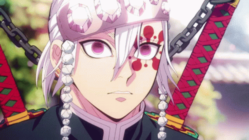 A Close Up Of A Person Holding A Sword With Blood On Their Face GIF
