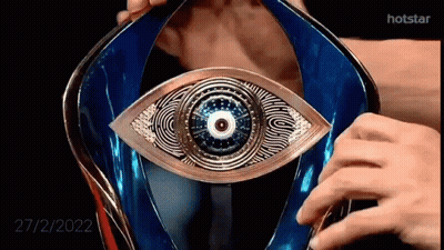 A Close Up Of A Person Holding A Trophy With An Eye In It . GIF