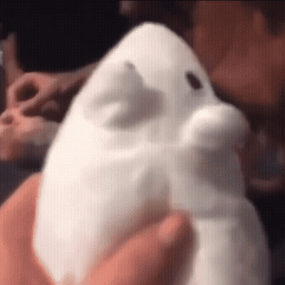 A Close Up Of A Person Holding A White Stuffed Animal . GIF