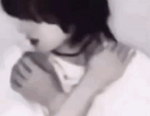 A Close Up Of A Person Holding Another Person 'S Neck And Shoulder . GIF