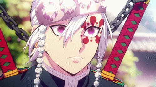 A Close Up Of A Person Holding Two Swords With Chains Around Their Neck GIF