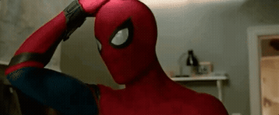 A Close Up Of A Person In A Spiderman Costume Holding Their Head . GIF