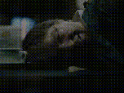 A Close Up Of A Person Laying Down With Their Head On A Table GIF