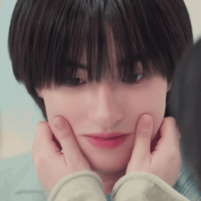A Close Up Of A Person Making A Face With Their Hands On Their Face . GIF