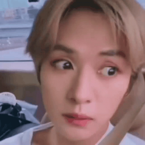 A Close Up Of A Person Making A Funny Face With Their Eyes Crossed . GIF