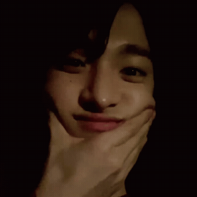 A Close Up Of A Person Making A Funny Face With Their Hand On Their Face . GIF
