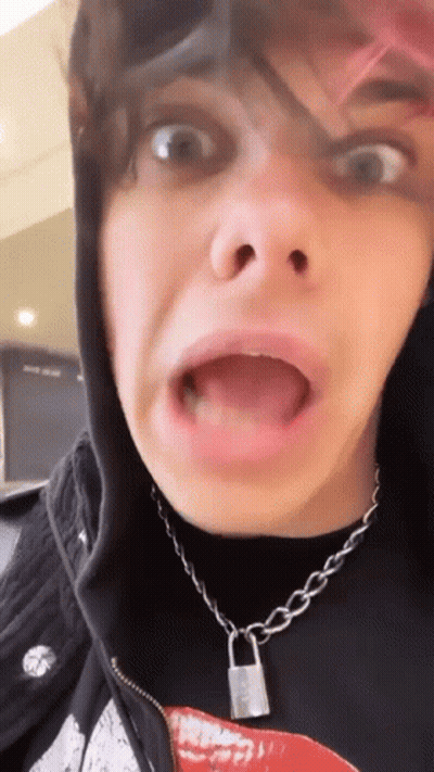 A Close Up Of A Person Making A Funny Face With Their Mouth Open . GIF