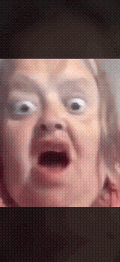 A Close Up Of A Person Making A Funny Face With Their Mouth Open . GIF