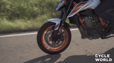 A Close Up Of A Person Riding A Motorcycle With The Words Cycle World On The Bottom Right GIF