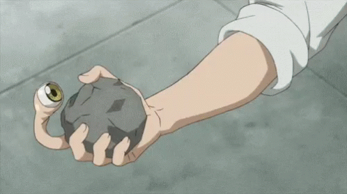 A Close Up Of A Person 'S Arm With Muscles And Claws Holding A Rock . GIF