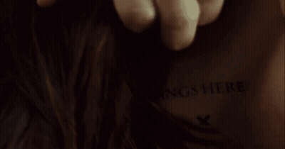 A Close Up Of A Person 'S Back With The Words Insert Fangs Here Written On It GIF