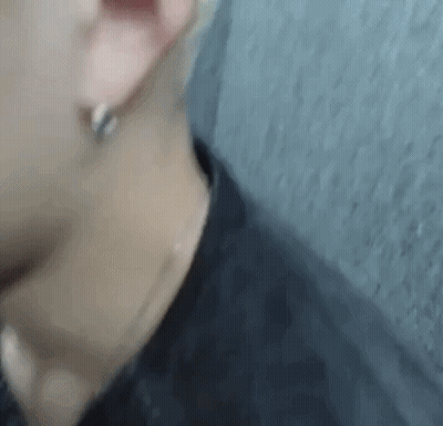 A Close Up Of A Person 'S Ear And Neck With Earrings . GIF