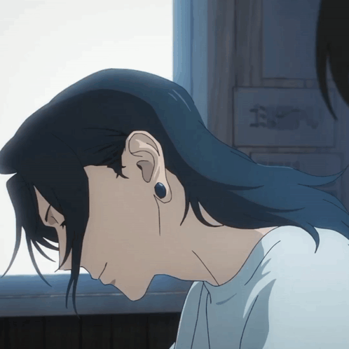A Close Up Of A Person 'S Ear With A Sign In The Background That Says " E " GIF