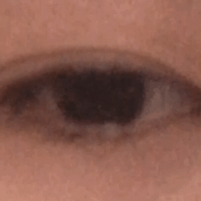 A Close Up Of A Person 'S Eye With A Black Pupil GIF