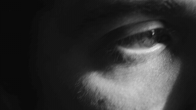 A Close Up Of A Person 'S Eye With A Dark Background GIF