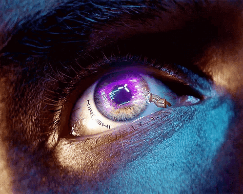 A Close Up Of A Person 'S Eye With A Purple Pupil That Says Atari Shi GIF