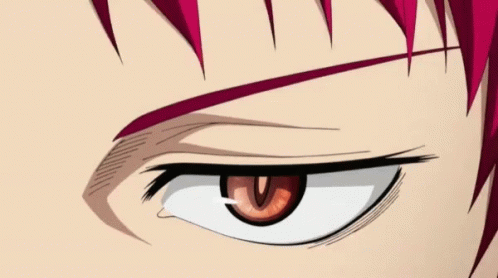 A Close Up Of A Person 'S Eye With Red Hair GIF