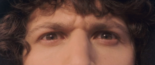 A Close Up Of A Person 'S Eyes With A Serious Look On His Face GIF