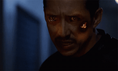 A Close Up Of A Person 'S Face Covered In Fire GIF