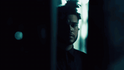 A Close Up Of A Person 'S Face In A Dark Room . GIF