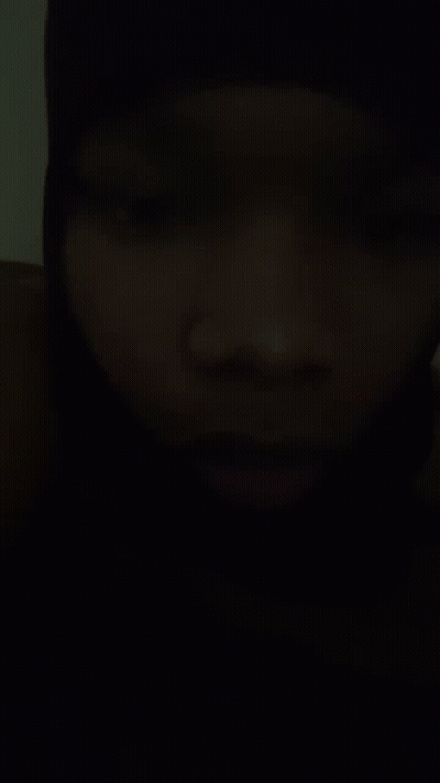 A Close Up Of A Person 'S Face In A Dark Room . GIF