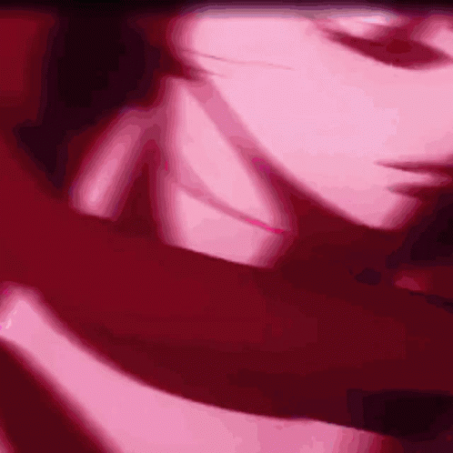 A Close Up Of A Person 'S Face In A Pink And Red Background GIF