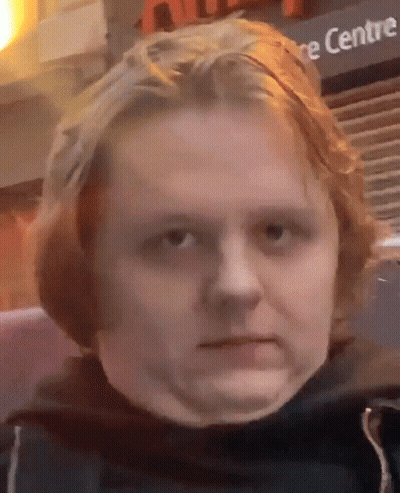 A Close Up Of A Person 'S Face In Front Of A Sign That Says ' Centre ' GIF