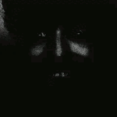 A Close Up Of A Person 'S Face In The Dark With Their Eyes Closed . GIF