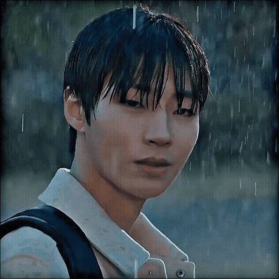 A Close Up Of A Person 'S Face In The Rain With A Backpack GIF