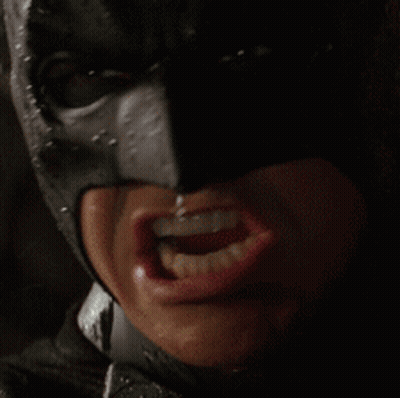 A Close Up Of A Person 'S Face Wearing A Batman Mask GIF