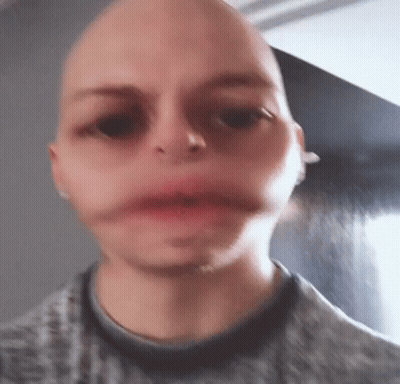 A Close Up Of A Person 'S Face With A Bald Head . GIF