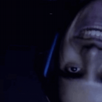 A Close Up Of A Person 'S Face With A Barcode In The Background That Says ' R & A ' GIF