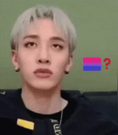 A Close Up Of A Person 'S Face With A Bisexual Flag In The Background And A Question Mark . GIF