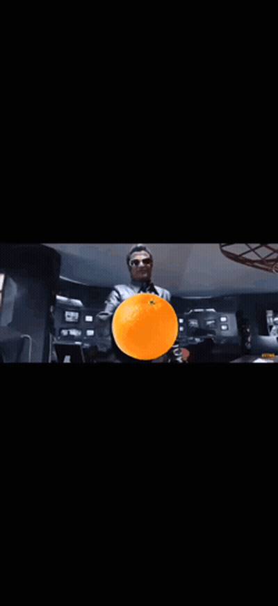 A Close Up Of A Person 'S Face With A Black Background And Orange Smoke Coming Out Of It . GIF