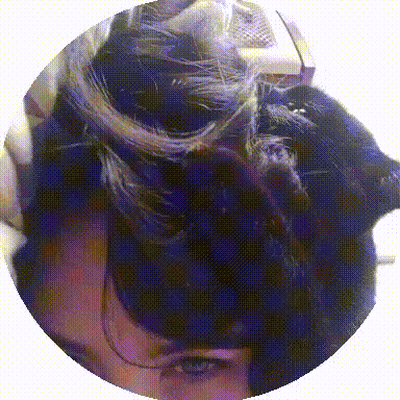 A Close Up Of A Person 'S Face With A Black Cat Laying On Top Of It GIF