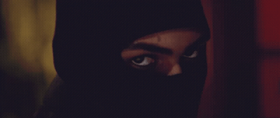 A Close Up Of A Person 'S Face With A Black Mask On GIF
