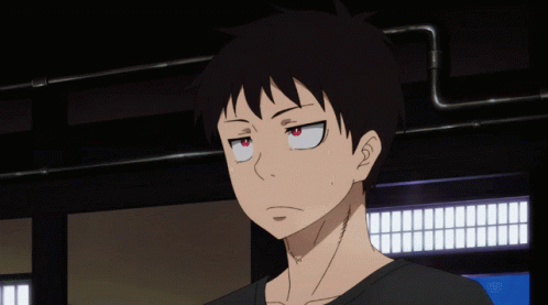 A Close Up Of A Person 'S Face With A Black Shirt And Red Eyes GIF