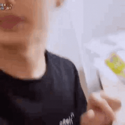 A Close Up Of A Person 'S Face With A Black Shirt On And A Backpack On . GIF