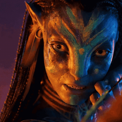 A Close Up Of A Person 'S Face With A Blue And Green Face Paint GIF