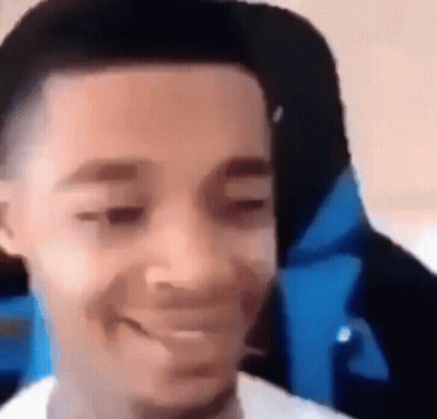 A Close Up Of A Person 'S Face With A Blue Jacket On . GIF