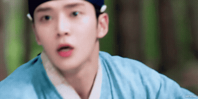 A Close Up Of A Person 'S Face With A Blue Shirt On GIF